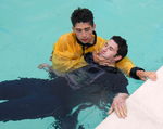RESCUES, CASUALTY, UNCONSCIOUS, TOW, 2 RESCUE BREATHING
Support the casualty for poolside resuscitation and do not touch the throat 15